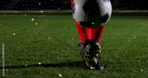 Canvastavla Kicking soccer player's lower legs contacting black-and-white ball on night pitc