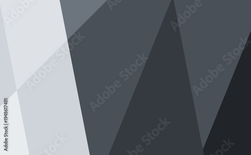 A modern abstract design featuring sharp, overlapping polygons in a sophisticated monochrome palette of dark charcoal, slate gray, and light silver.
