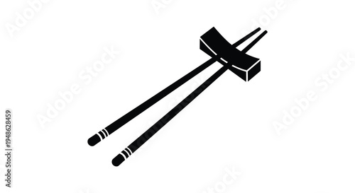 Black chopsticks crossed over a rectangular rest isolated on a white background