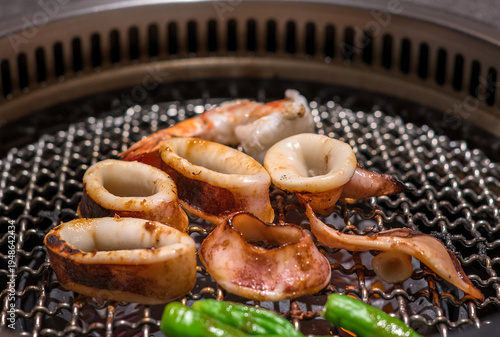 Raw beef slice on grille for barbecue or Japanese style yakiniku