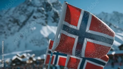 Norway flags waving in snowy mountains.