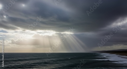 Brooding leaden clouds with rain shafts reaching across the dark ocean.