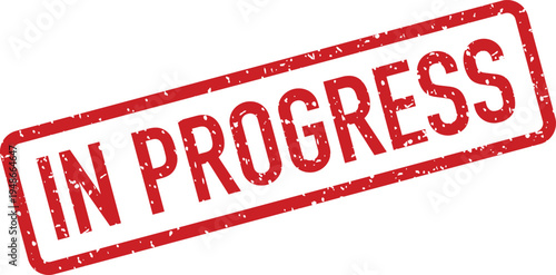 A bold red grunge rubber stamp clearly shows the words IN PROGRESS in capital letters on a bright white background