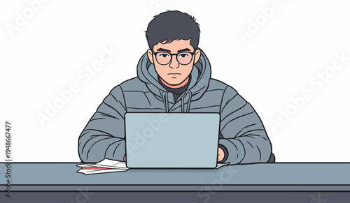 Young person works on laptop at desk focused on task during daytime in indoor space