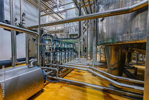 Pipe stainless steel tanks with pressure meter in equipment tank chemical cellar at the with stainless steel