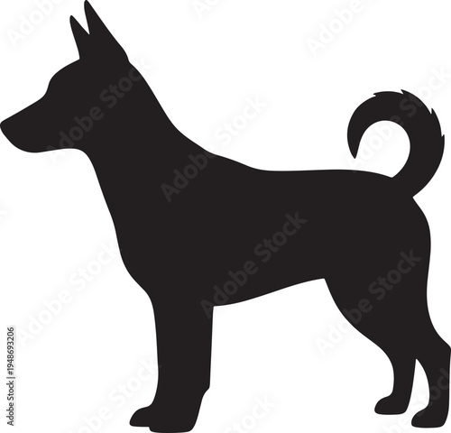 Black silhouette of dog standing sideways  looking left