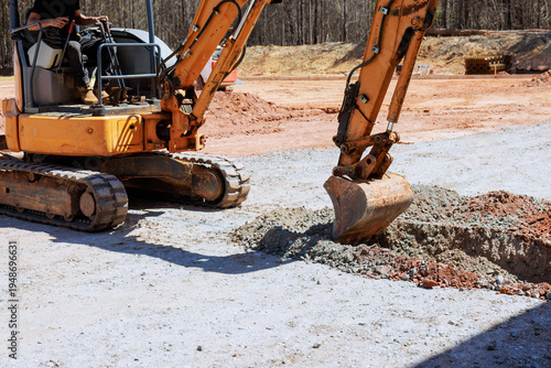 Photos Heavy machinery digs hole at construction site