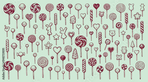 A large collection of various lollipops and candies in different shapes and sizes, arranged on a light green background.