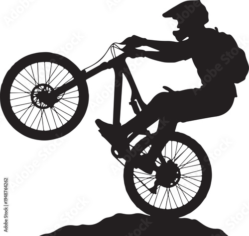 Silhouette of a mountain biker doing a wheelie stunt isolated on white