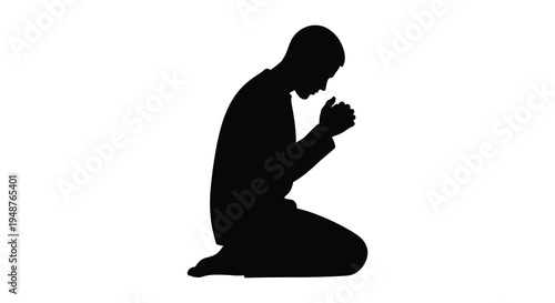 A man kneeling in prayer head bowed and hands clasped presented as a striking silhouette
