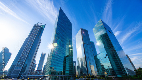Modern Blue Glass Skyscraper Cityscape with Bright Sun and Clear Sky