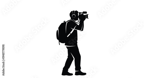 Silhouette of a traveling videographer wearing headphones and carrying a backpack while operating a video camera.