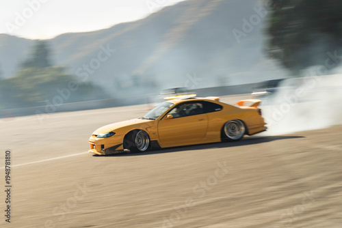 Bild auf Leinwand Yellow car drifting on a race track