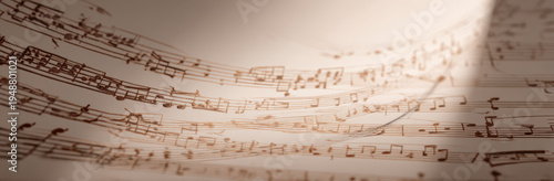 Beautiful music sheet background with intricate notes and symbols, creating sense of harmony and creativity. warm tones evoke nostalgic feeling of musical artistry