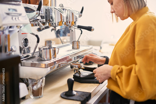 Barista making coffee with coffee machine