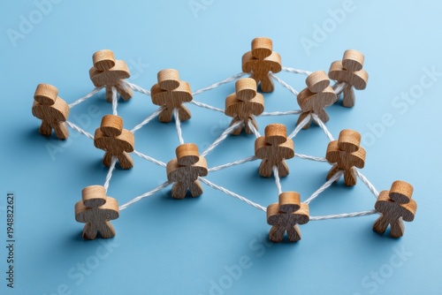 Network of Connection: Wooden figures interconnected by delicate threads illustrate the concept of community, emphasizing unity and the strength of interconnectedness.
