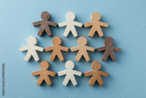 Harmony of Diversity: A symbolic representation of unity, featuring a collection of diverse wooden figures arranged together to represent togetherness and inclusion.