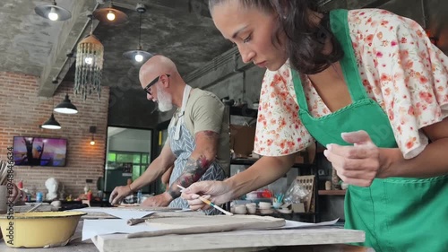 A happy couple makes ceramic plates in a workshop