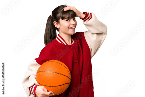 Little caucasian girl playing basketball over isolated background doing surprise gesture while looking to the side