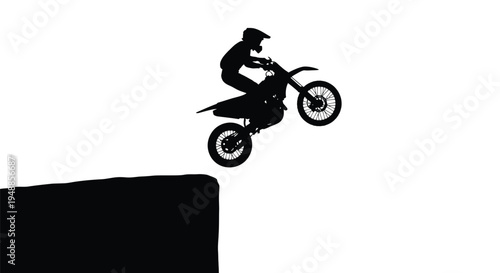 Motorcross rider performing a jump against a bright background silhouette
