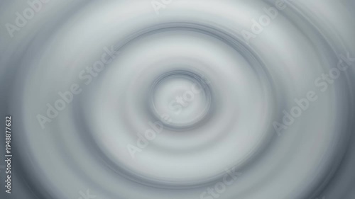 Soft radial blur abstract featuring gentle, concentric rings in shades of gray and white