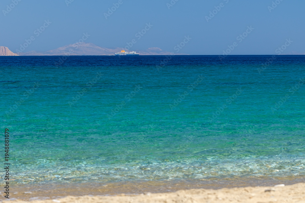 Fototapeta premium View of the crystal clear waters of the turquoise dream beach of Agia Theodoti in Ios Greece