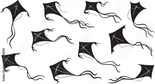 Black kites flying in the air with long tails