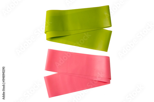 Set of elastic bands for fitness isolated on white. Pink and green fitness bands of different resistance levels.