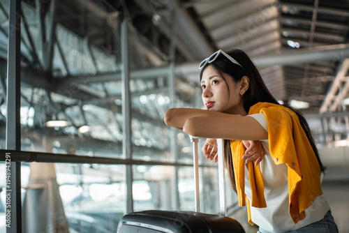 Unhappy young woman traveler disappointed with flight delay or cancelation while waiting at airport terminal, female tourist upset after receiving bad news when sitting at airline lounge.