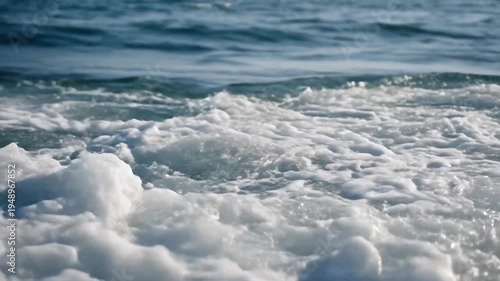 Dynamic Ocean Wave Crashing with White Foam and Blue Water.
