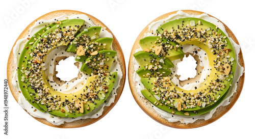 Two bagels with avocado and sesame.