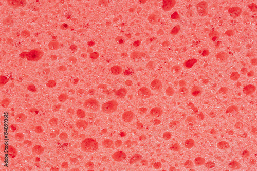 Quadro su tela Macro shot of a red foam sponge surface showing a complex network of open cells and polymer fibers