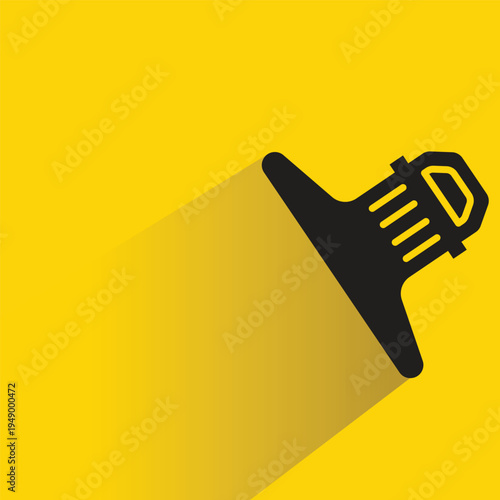 paper clip icon with shadow on yellow background