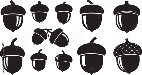 Collection of black acorn silhouettes on white background illustration