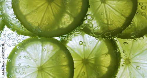 Lime Slices falling deeply under water. Shot on super slow motion camera 1000 fps.