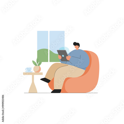 A man relaxes indoors, sitting comfortably in a bean bag chair and using a tablet, with a view of nature visible outside a window.