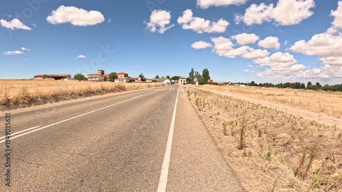 French Way of Saint James - P-980 paved road entering Villarmentero de Campos, province of Palencia, Castile and Leon, Spain