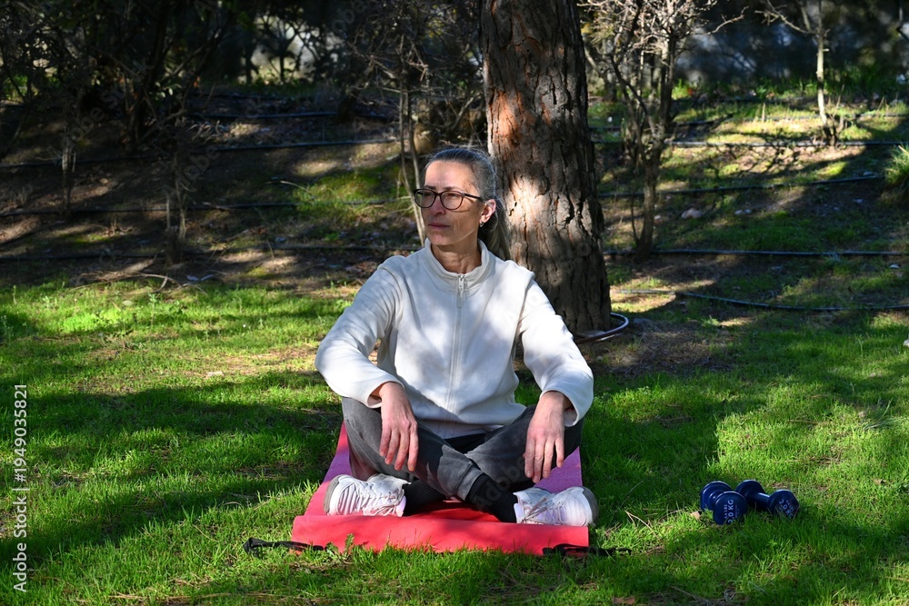Fototapeta premium Active senior woman exercising in the park on a spring day