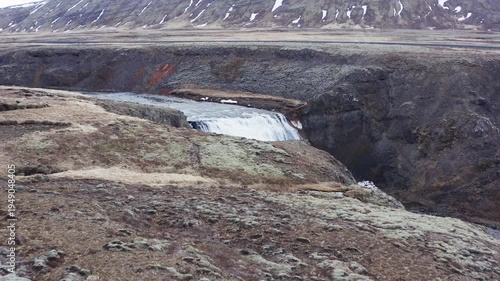 aerial view of Thorufoss waterfall and Laxá í Kjós river in a rocky Icelandic landscape.
