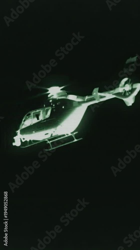 TV helicopter with a camera attached for filming and surveillance in the sky. Negative video or night vision effect