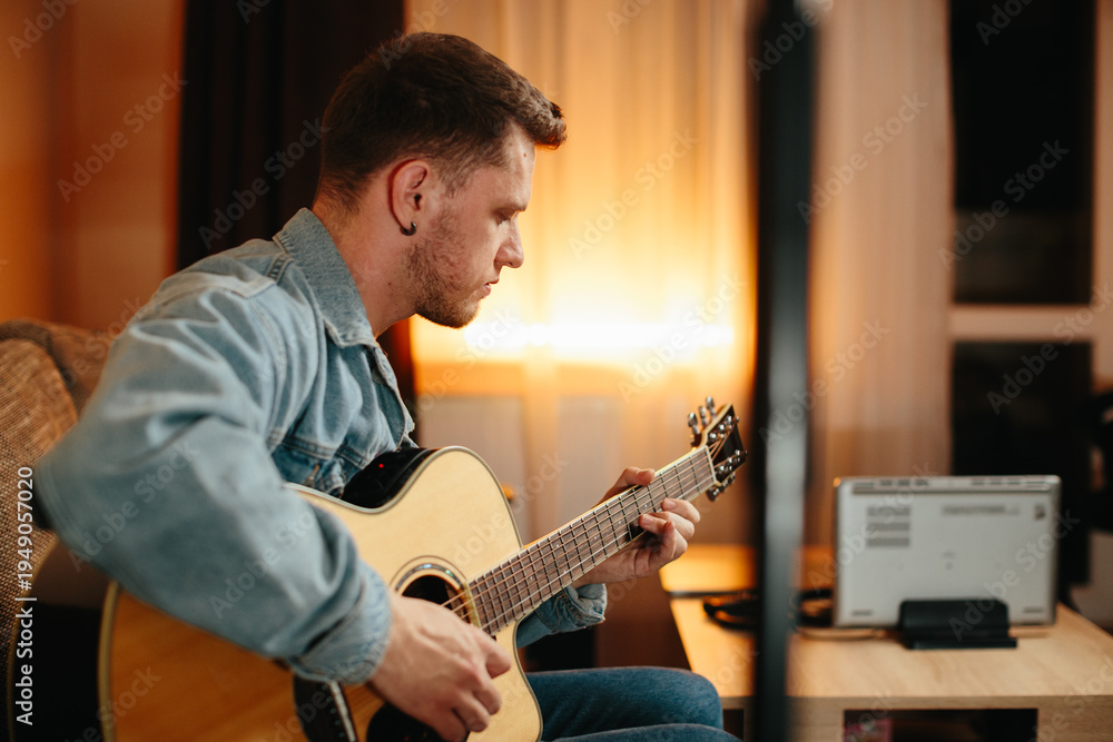 Obraz premium Musician composing music playing acoustic guitar at home