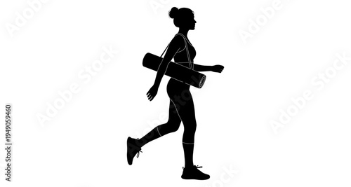 Silhouette of a woman walking with a yoga mat over her shoulder