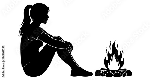 Silhouette of a woman sitting by a campfire in a black and white