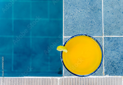 Refreshing summer cocktail by the swimming pool