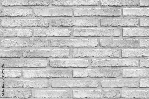 Clean, weathered brick wall in soft gray tones. Uniform rows show subtle texture and age. Perfect for rustic or minimalist design backdrops. Neutral palette suits modern interiors or urban themes