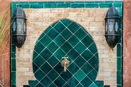 Elegant Moroccan gold tap with ornate tile backdrop