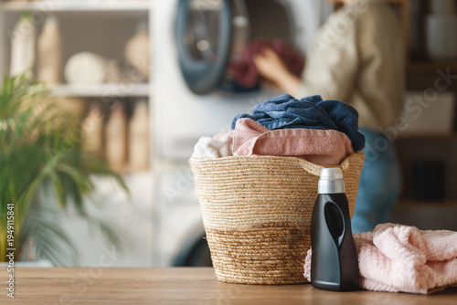 Cozy Modern Laundry Room with Basket of Fresh Towels and Deterge