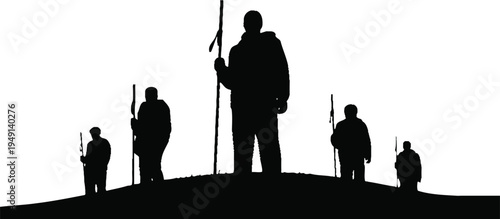 Silhouette of a group of people standing on a hill