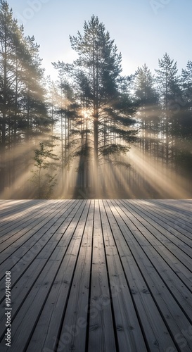 Sunlight streaming through pine trees over a wooden deck at dawn