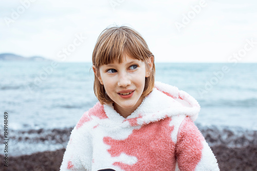 little cute blond girl curious smiling playing outside on sea, lifestyle people concept
